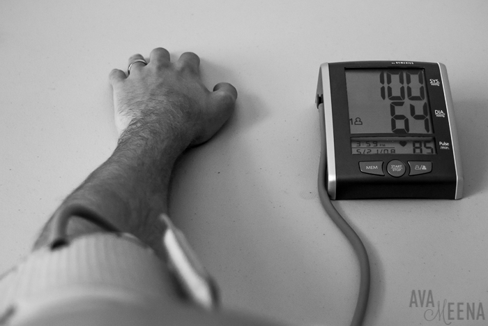 My husband using my blood pressure monitor. | Going through the depths of my sickness with lupus.